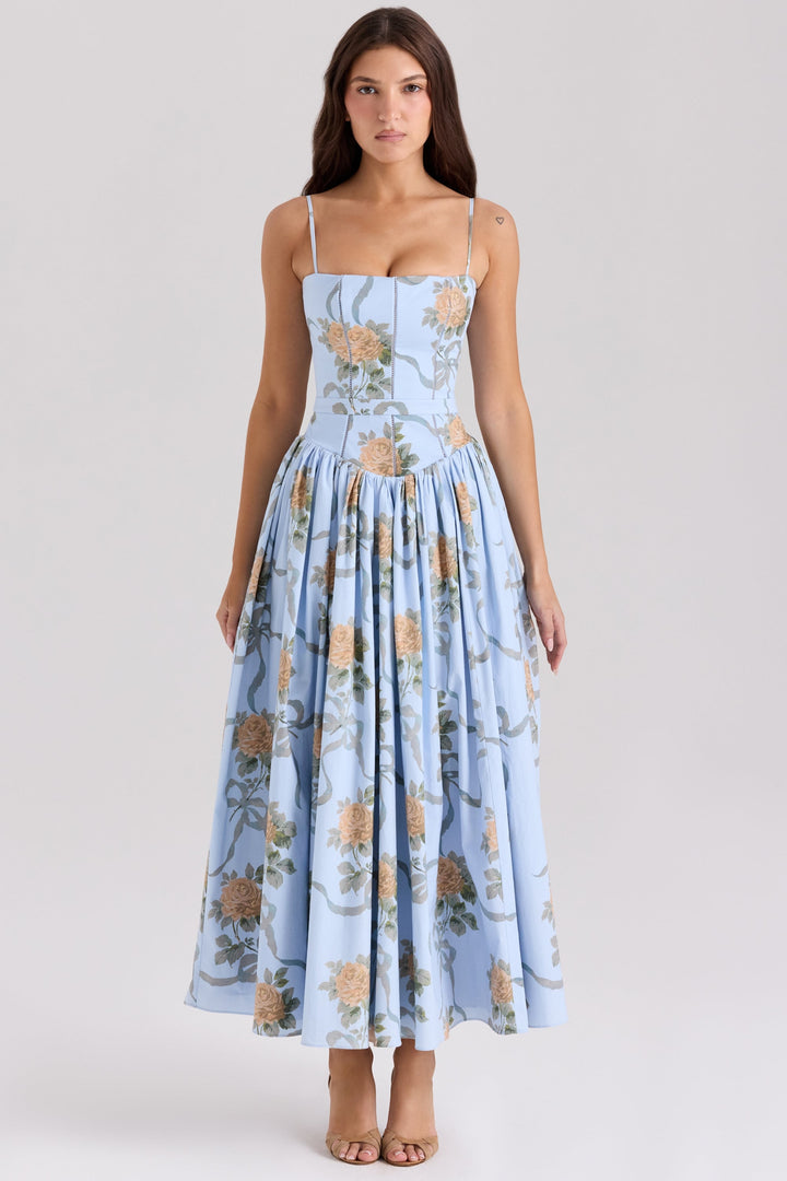 Front view, model wearing a light blue cotton maxi sundress with peach roses and grey ribbon print