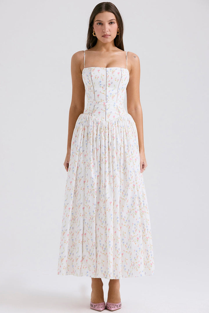 Front view, model wearing a white cotton maxi sundress with delicate floral print and fine shoulder straps