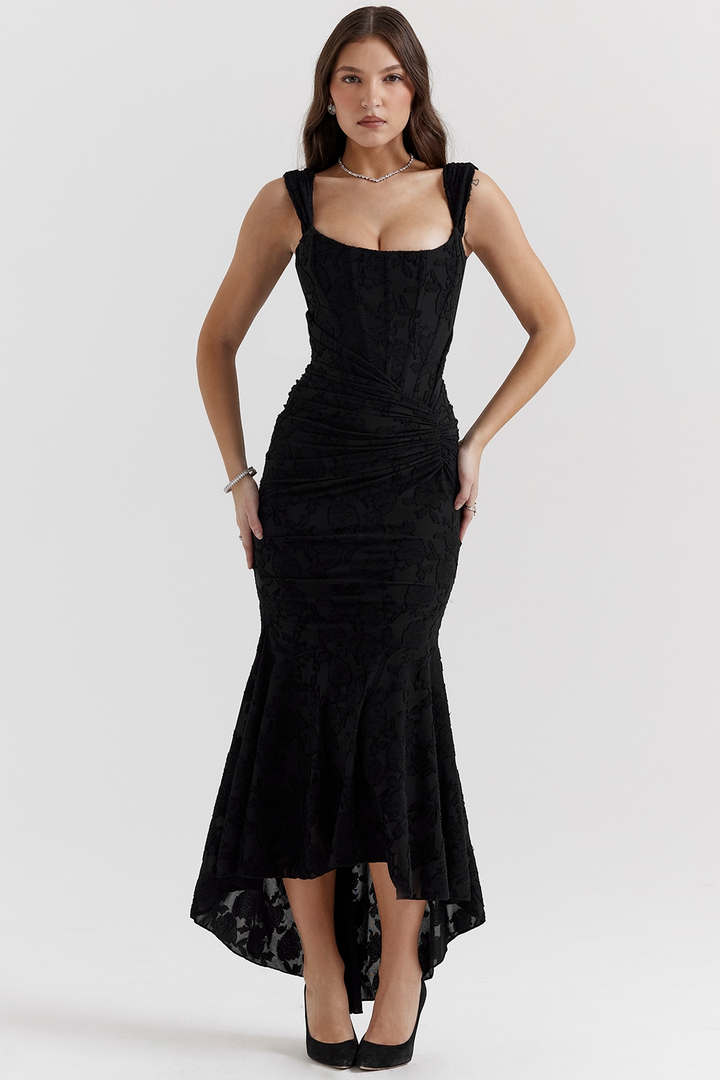 Front view, model wearing a black one-shoulder fishtail maxi dress with a bodycon fit and floral texture