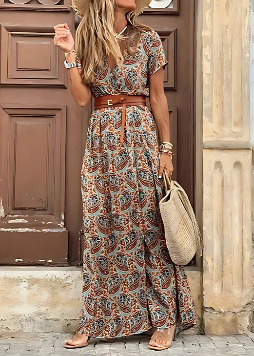 Long Bohemian Dress, worn by model, three quarter view, with a pleated waist and a wide brown belt