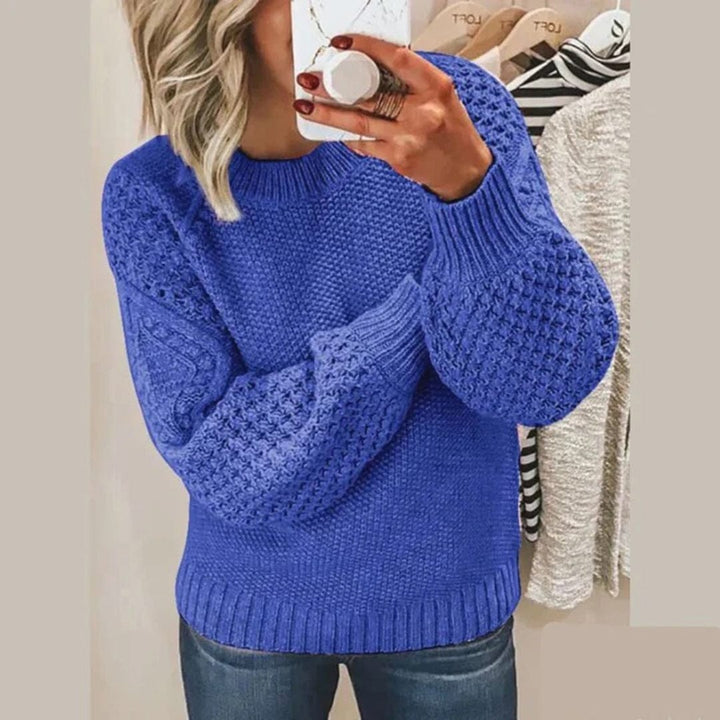 Close up of a woman wearing the Aria soft cotton jumper, showing the textured knit and ribbed cuffs