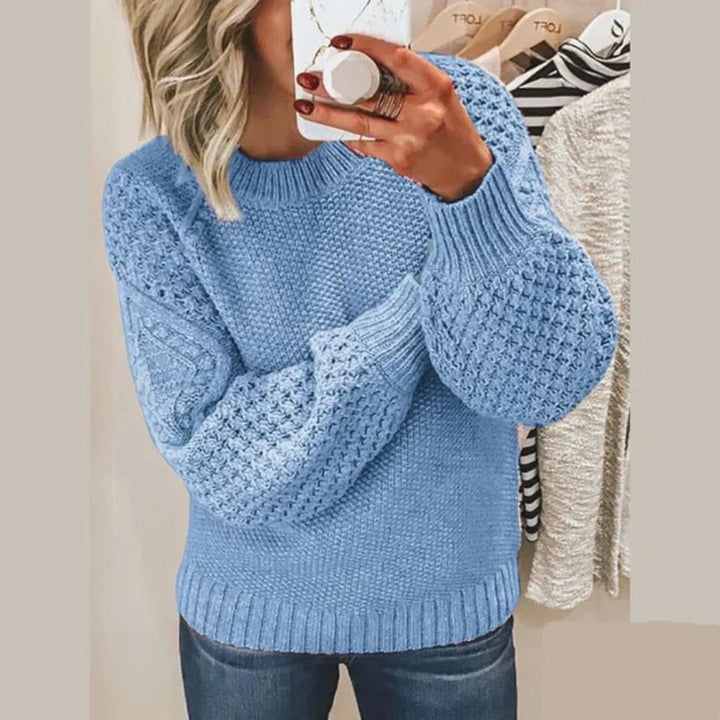 Front view of a woman wearing the Aria soft cotton jumper in blue, showing the textured knit and balloon sleeves