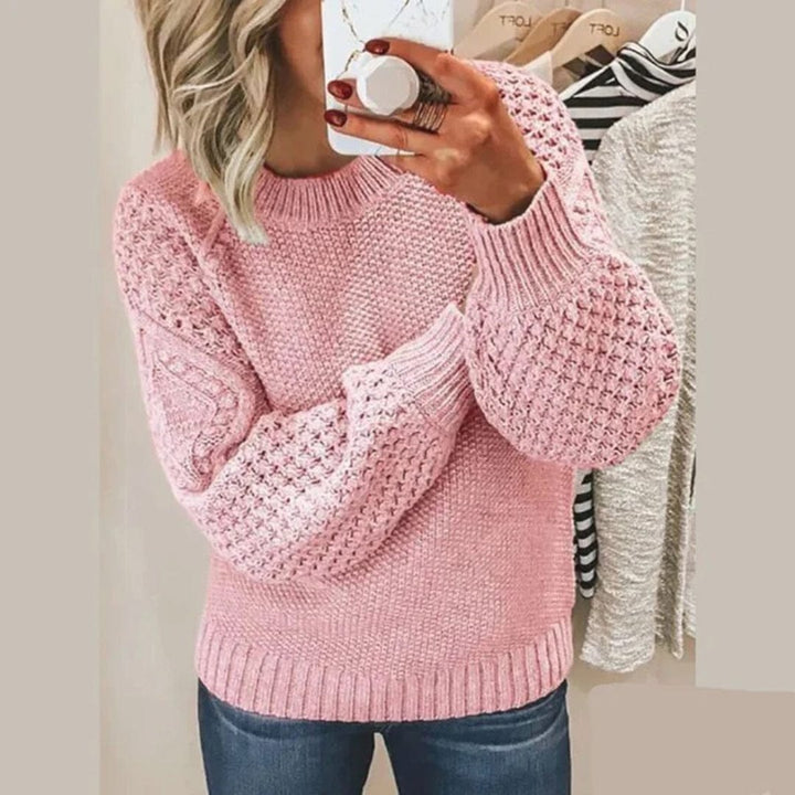 Front view of a woman taking a mirror selfie wearing the Aria soft cotton sweater in pink