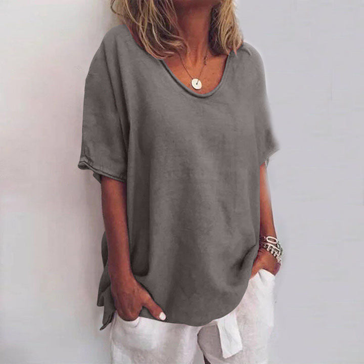 Front view of a model wearing the relaxed comfort shirt in grey with a scooped neckline and short sleeves