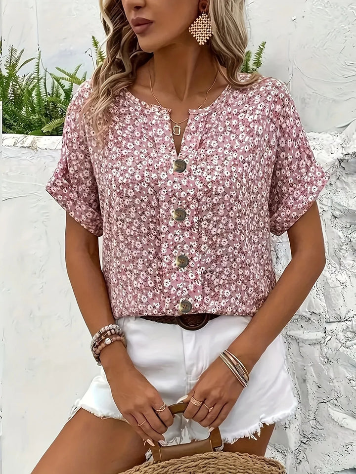 Dusty pink floral print blouse with white shorts and a woven bag