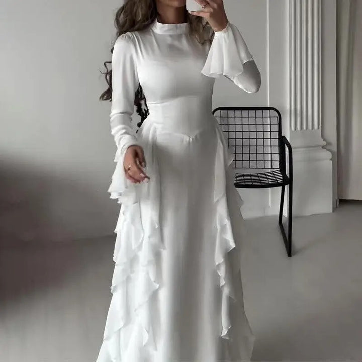 Front view of a model wearing the white elegant patchwork maxi dress with bell sleeves and ruffled skirt layers