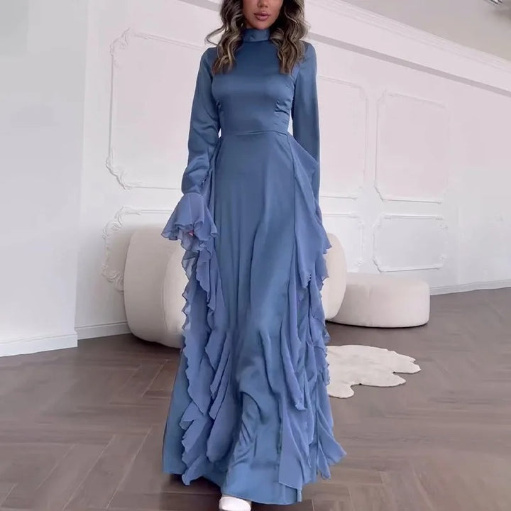 Front view of a model wearing the blue elegant patchwork maxi dress with bell sleeves and ruffled skirt detail