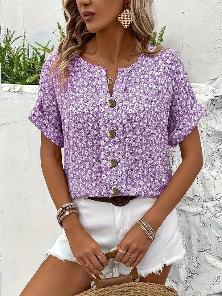 Light purple floral print blouse worn with white shorts, three quarter view