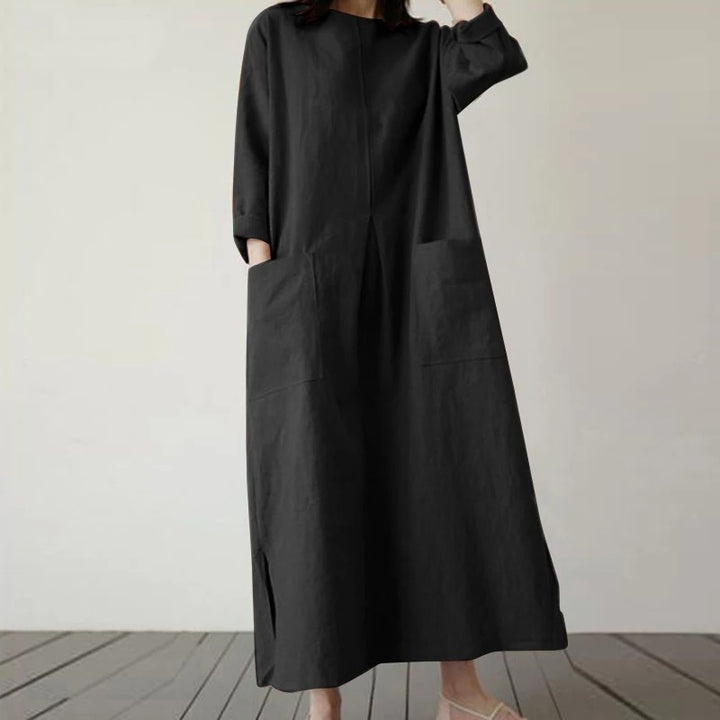 Front view of a model wearing the Georgia summer vintage baggy loose casual dress in classic black with side slits