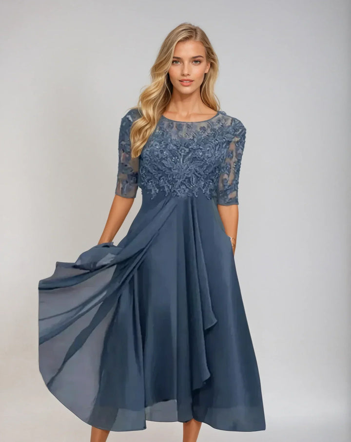 Front view of a model in an elegant chiffon lace long dress with sheer sleeves and embroidered bodice