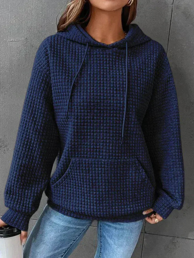 Front view of a model wearing the navy blue oversized cotton hoodie with waffle texture and front pocket