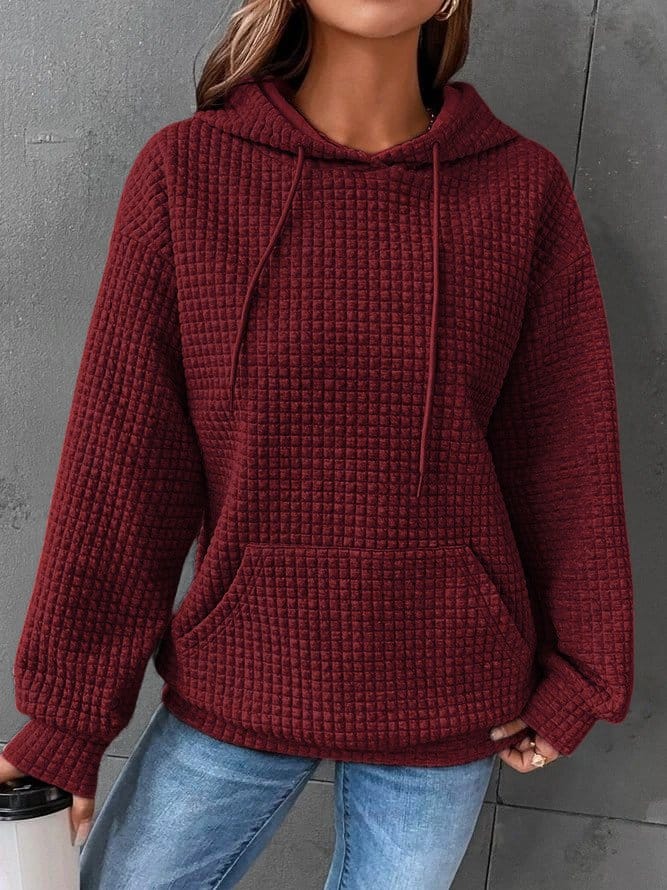 Front view of a model wearing the burgundy oversized cotton hoodie with waffle texture, drawstring, and front pocket