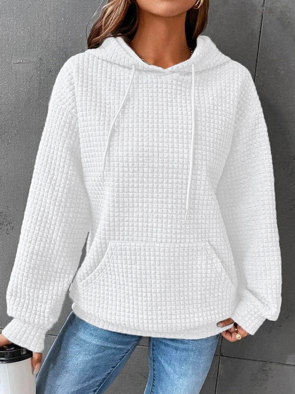 Front view of a model wearing the white oversized cotton hoodie with waffle texture, drawstring, and front pocket
