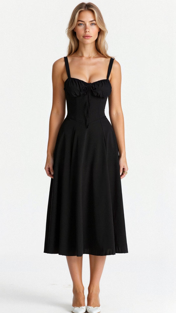 Front view, model wearing a black waist-emphasising bustier dress with delicate straps, on a white background