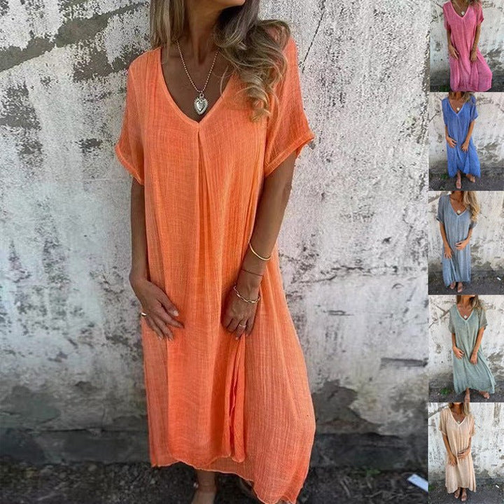 Front view of a model wearing the elegant midi V-neck summer dress in peach, with other colours in small insets
