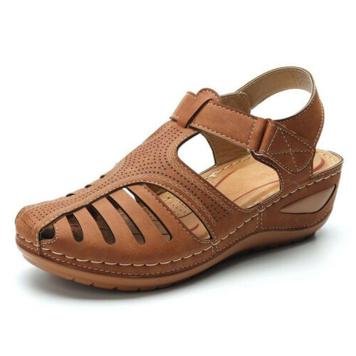 Side view of a single brown orthopedic summer sandal with cutouts, perforated detail, and white stitching
