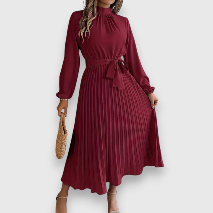 Malia Pleated Midi Dress, worn by model, front view, in burgundy with a high neck and tie waist