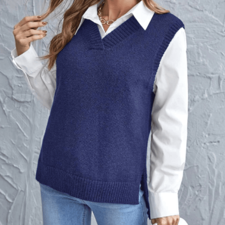 Close up front view of a model wearing a navy V-neck knit sweater vest over a white collared shirt