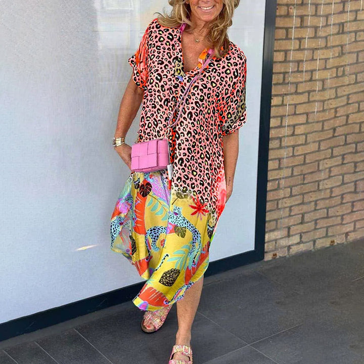 Front view of a model wearing a casual leopard print dress with a vibrant boho maxi skirt and pink sliders