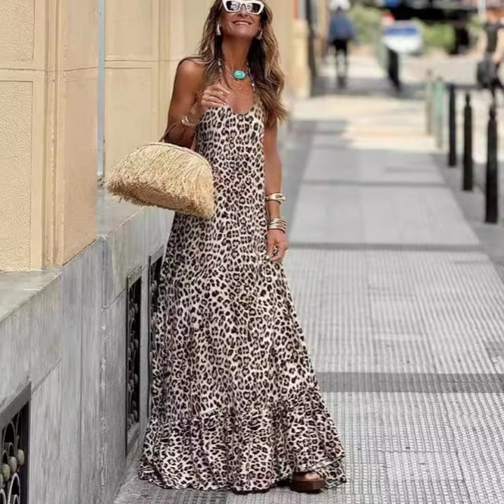 Leopard Print Halter Maxi Dress worn by model, three quarter front view, with a straw bag and sunglasses