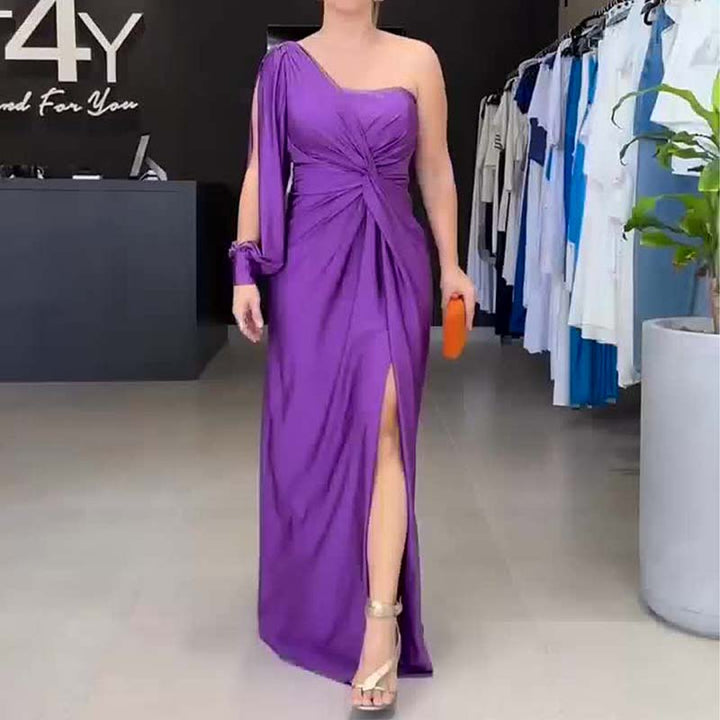 Front view, model in a purple one-shoulder maxi dress with a draped bodice and thigh split, holding an, alternate angle
