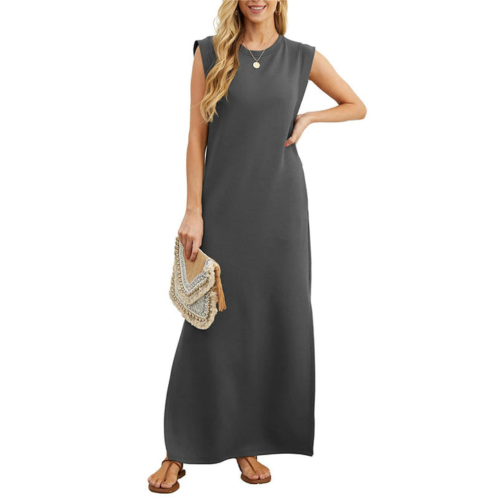 Front view worn by model, a dark grey crease-resistant maxi dress with brown sandals and a beaded clutch