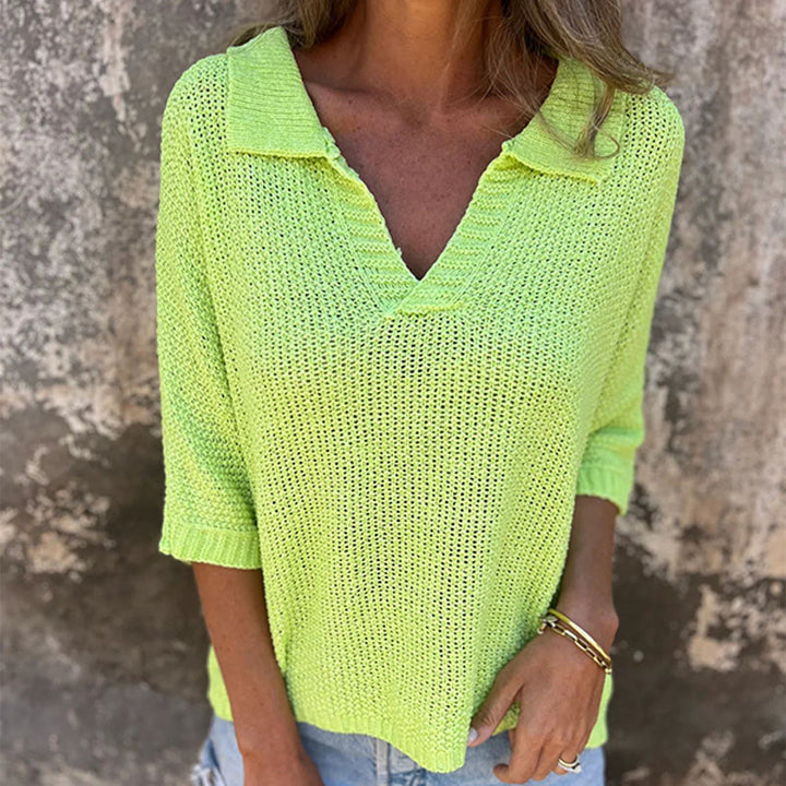 Front view worn by model, a woman in a bright green Lina V-neck top with a collared neckline and gold bracelets