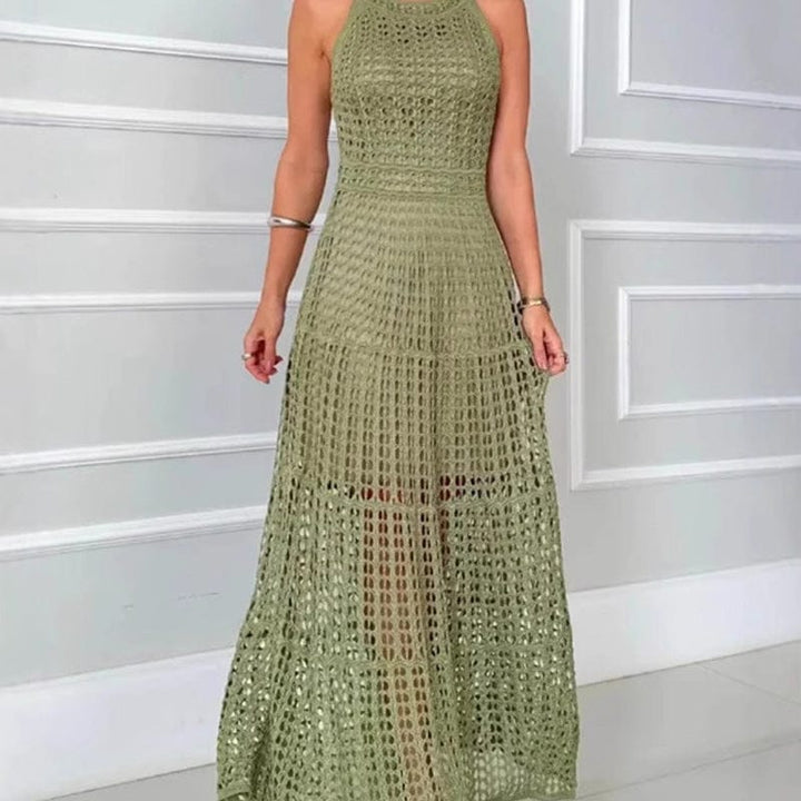 Front view, model wearing an A-line crochet maxi dress in olive green with hollow-out detail and a nude slip