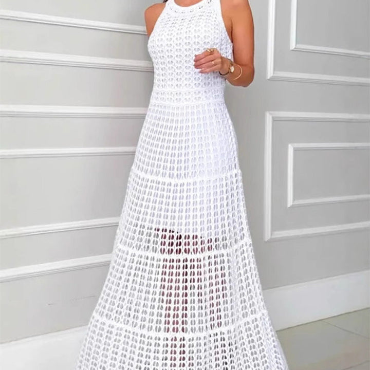 Front view, model wearing a white A-line crochet maxi dress with hollow-out detail and a nude slip