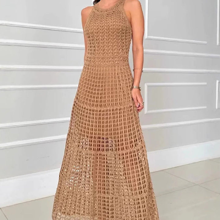 Front view, model wearing a brown A-line crochet maxi dress with hollow-out detail and a nude slip