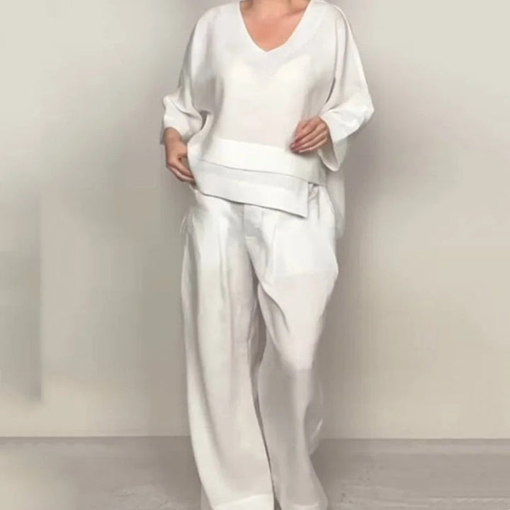 Front view worn by model, white V-neck jumpsuit with wide-leg pants and loose fit