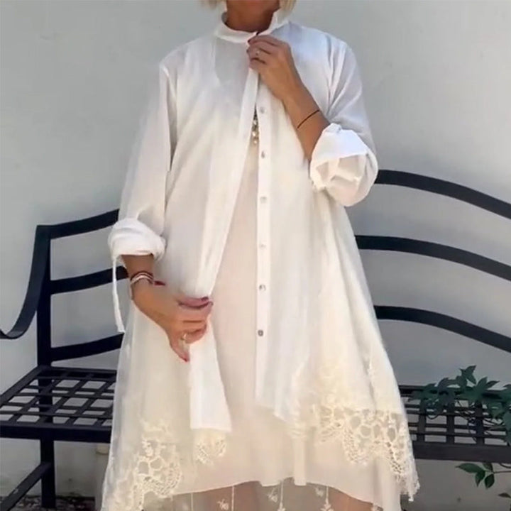 Front view of a model wearing a white sleeveless dress with a white lace vest set, showing the full length