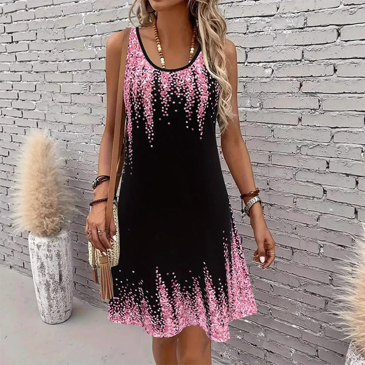 Front view worn by model, a black sleeveless mini dress with pink speckled pattern on the O-neck and hem