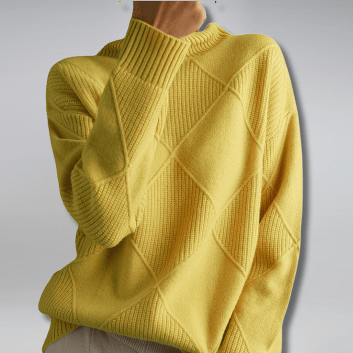 Side view of a model wearing a yellow check turtleneck knit sweater with textured diamond patterns