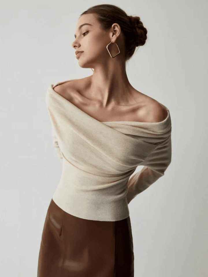 Front view, model wearing off shoulder knit sweater with long sleeves and brown skirt, looking to the side