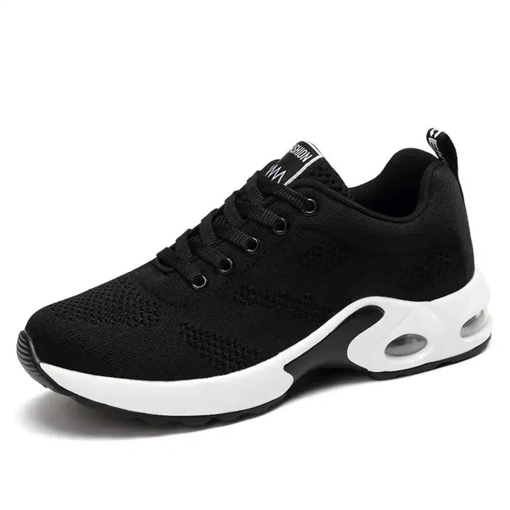 Side view, black retro coloured pain-relieving sneakers with white soles and visible air cushions