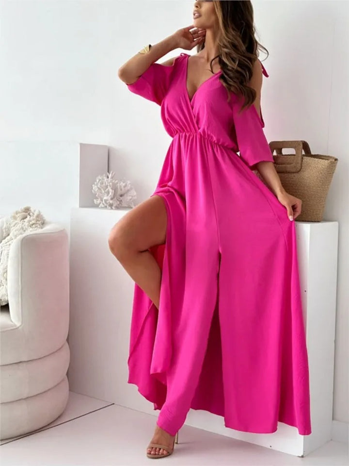 Front view of a model wearing a hot pink elegant maxi dress with cold shoulder sleeves and a high split