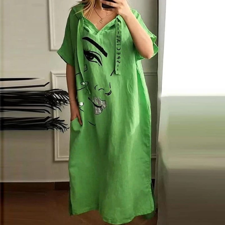 Front view of a model wearing a green retro abstract hooded dress with an art-inspired face print and pockets