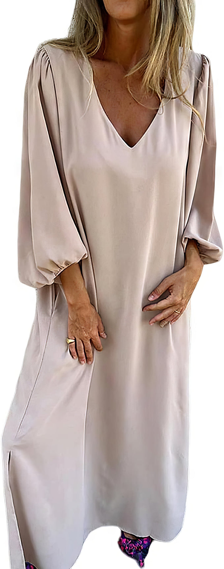 Front view of a woman wearing a beige bohemian maxi dress with pockets and a side slit