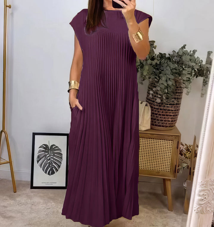 Plum pleated sleeveless dress with a hand in the pocket, front view