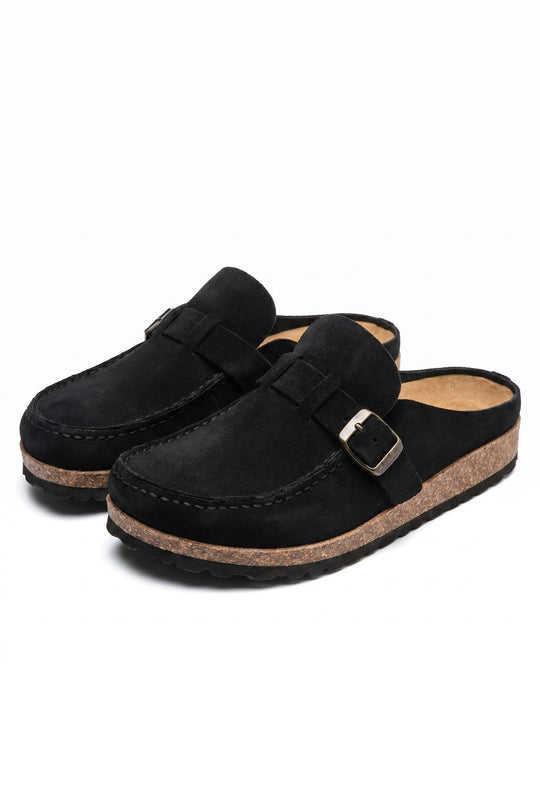 Front view of a pair of black suede loafers with buckle detail and cork-like soles