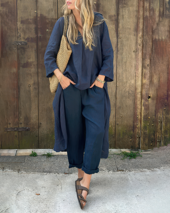 Front view of a model wearing a navy casual two-piece set with a long V-neck top and cuffed pants