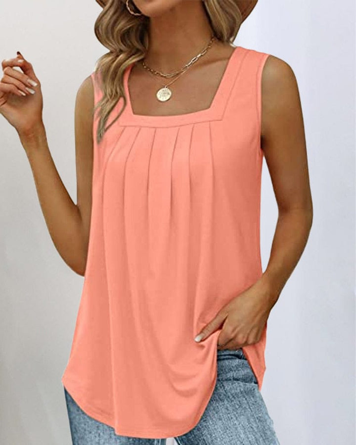 Front view of a woman wearing a sleeveless square neck tank top in peach with pleated detailing