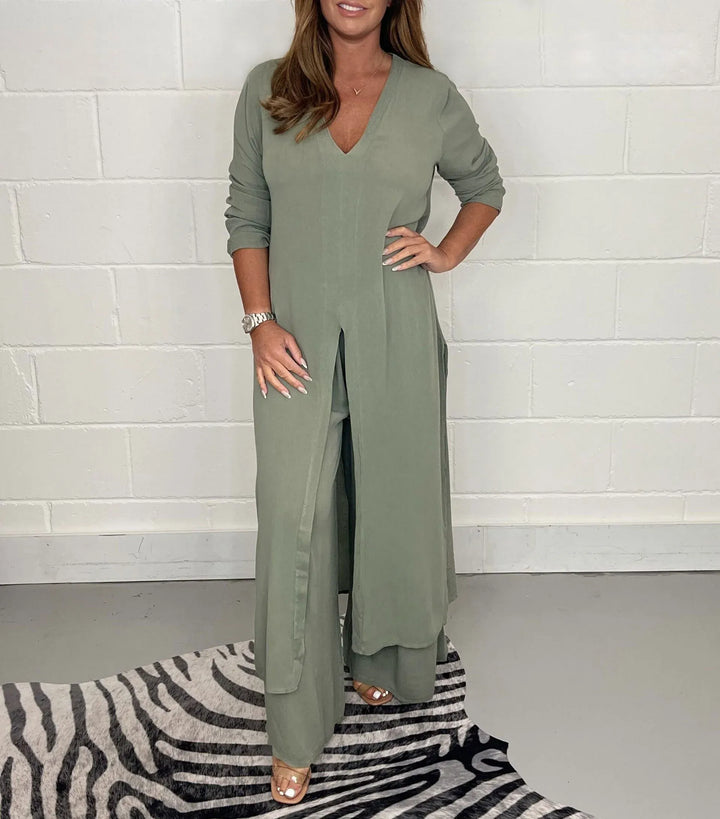 Front view of a model wearing a jade two-piece wide leg jumpsuit set with a long tunic top and v-neck