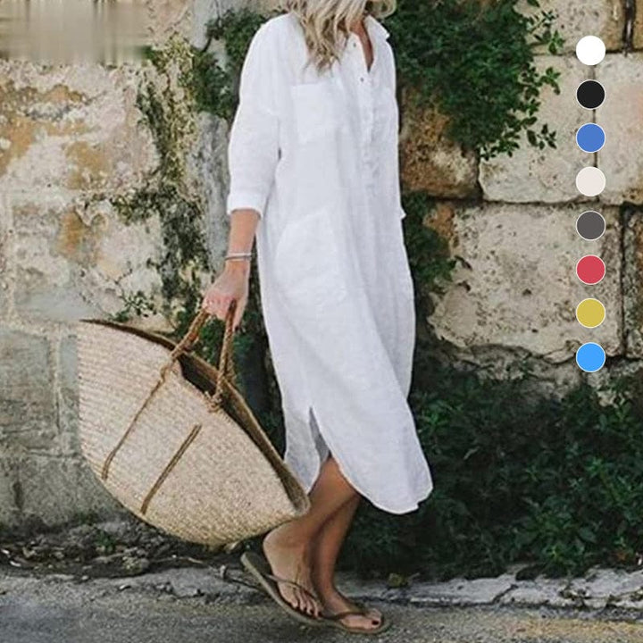 Front view of a model wearing the white elegant solid colour slit shirt dress, carrying a straw bag