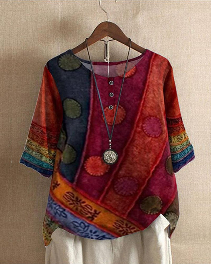Front view of a Lacey Casual Blouse with half sleeves and a vibrant digital print, on a hanger