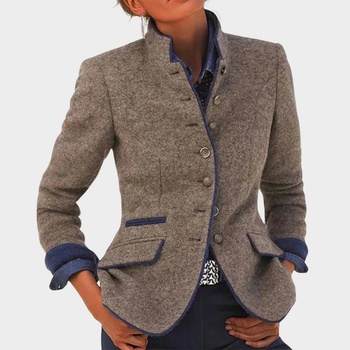 Front view of an elegant long-sleeve jacket in grey with blue trim, worn by a model