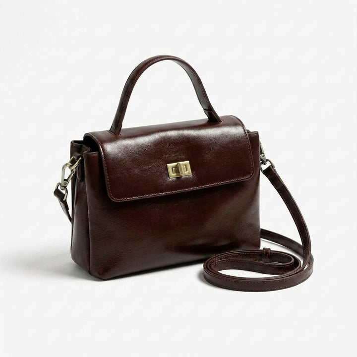 Front view of a brown Giselle leather tote bag with a top handle and shoulder strap