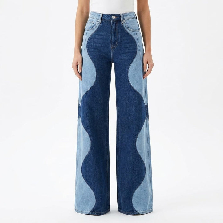 Front view of high-waisted wide leg boho vintage pants with wavy light and dark denim panels worn by model