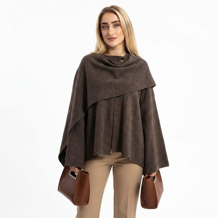 Front view worn by model of a dark brown asymmetric knit scarf jacket with a button at the collar
